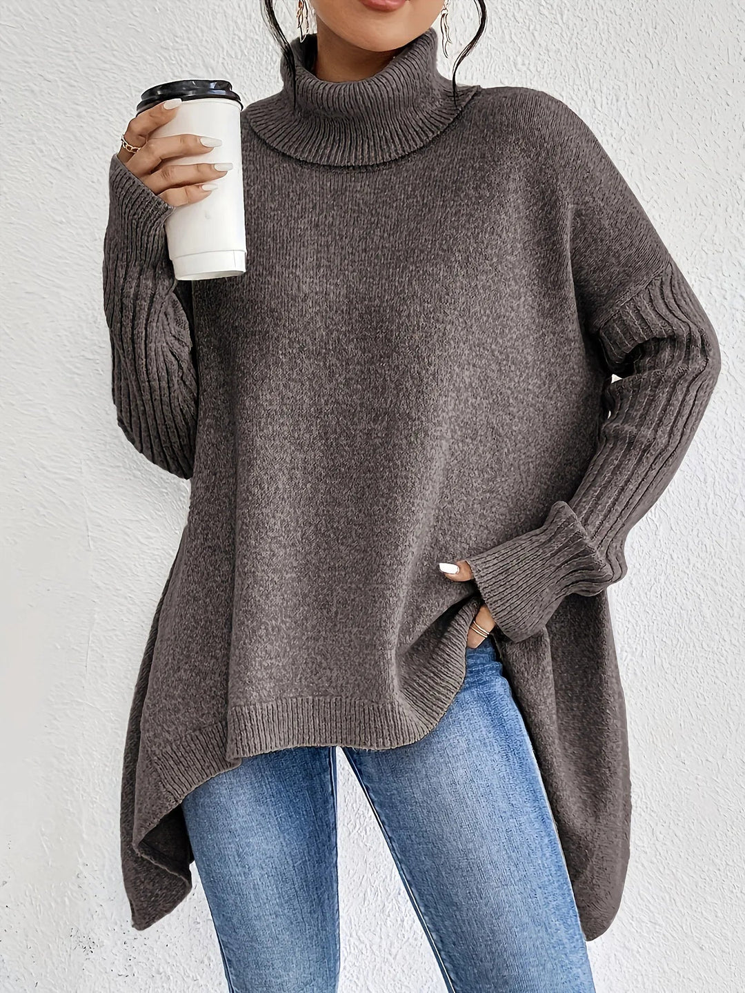 Oversize strikbluse med rullekrave – asymmetrisk